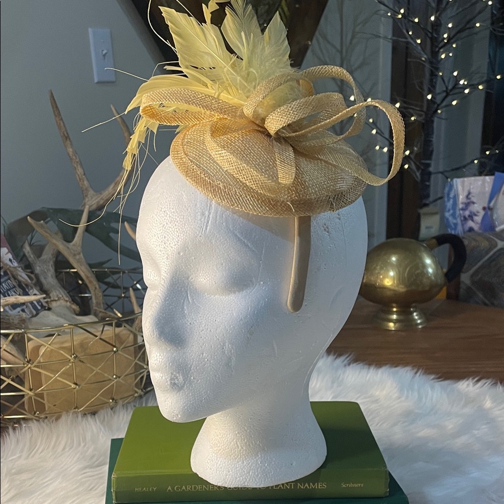 Fascinator Headband. Light yellow feathers on a light tannish cap with bows.